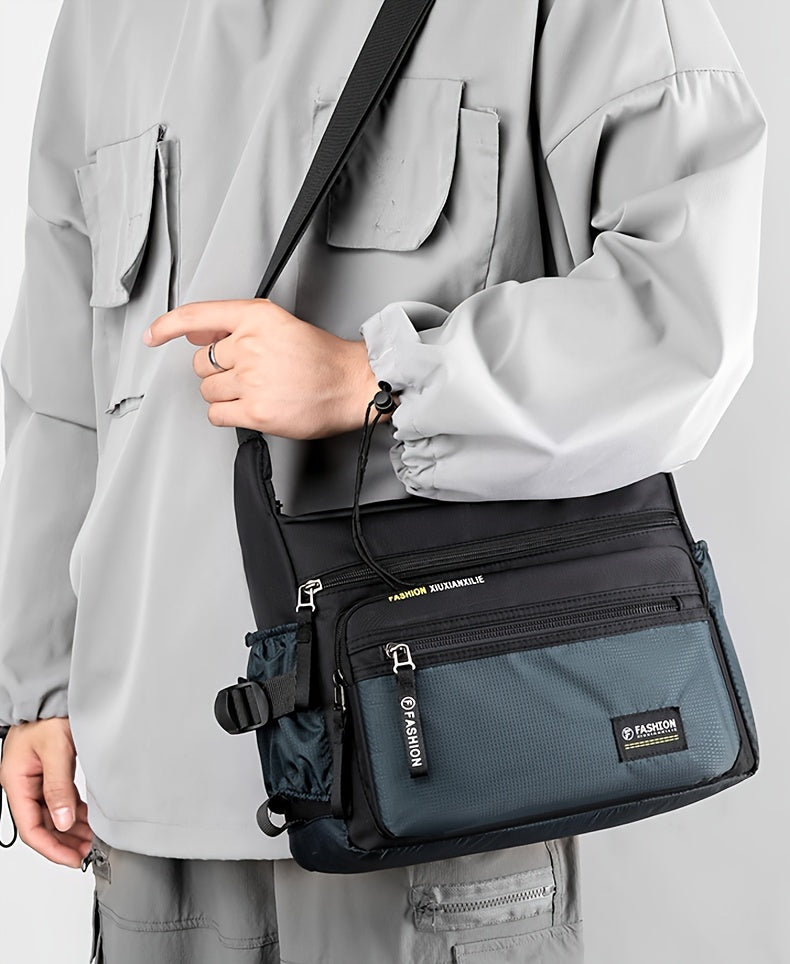 A woman wearing a light gray jacket holds a black multifunctional crossbody bag.