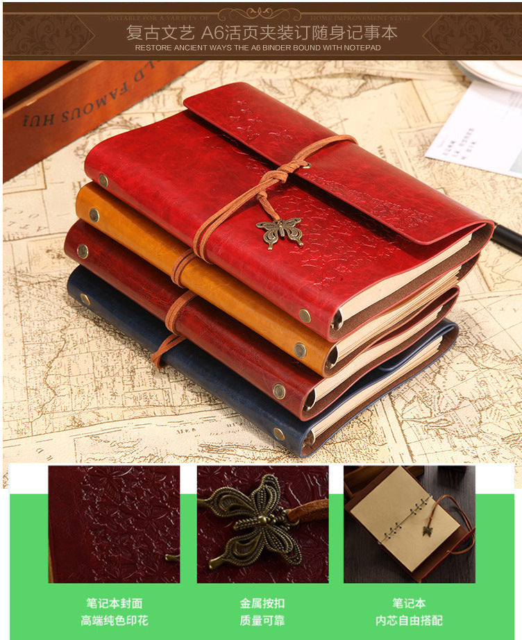 A stack of red and brown leather-bound A6 journal notebooks tied with twine, featuring a decorative butterfly clasp.