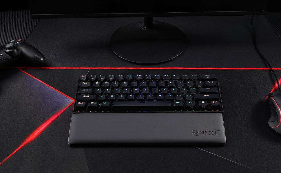 A black ergonomic memory foam keyboard wrist rest with an anti-slip base is shown on a dark surface.