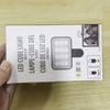 A box for a LED cube light with clip and a cube of light, shown next to a photo example.