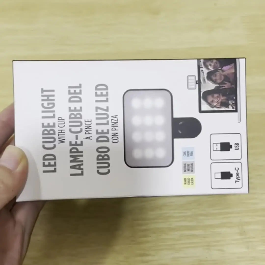 A box for a LED cube light with clip and a cube of light, shown next to a photo example.