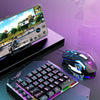 A black T-Wolf mobile gaming keyboard and mouse combo with a laptop displaying a game.