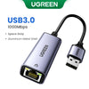 A silver UGREEN USB 3.0 to Ethernet adapter with a metal shell and cable.