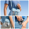 A hand holds a mini portable ice cooling fan inside a light blue backpack and a smartphone.