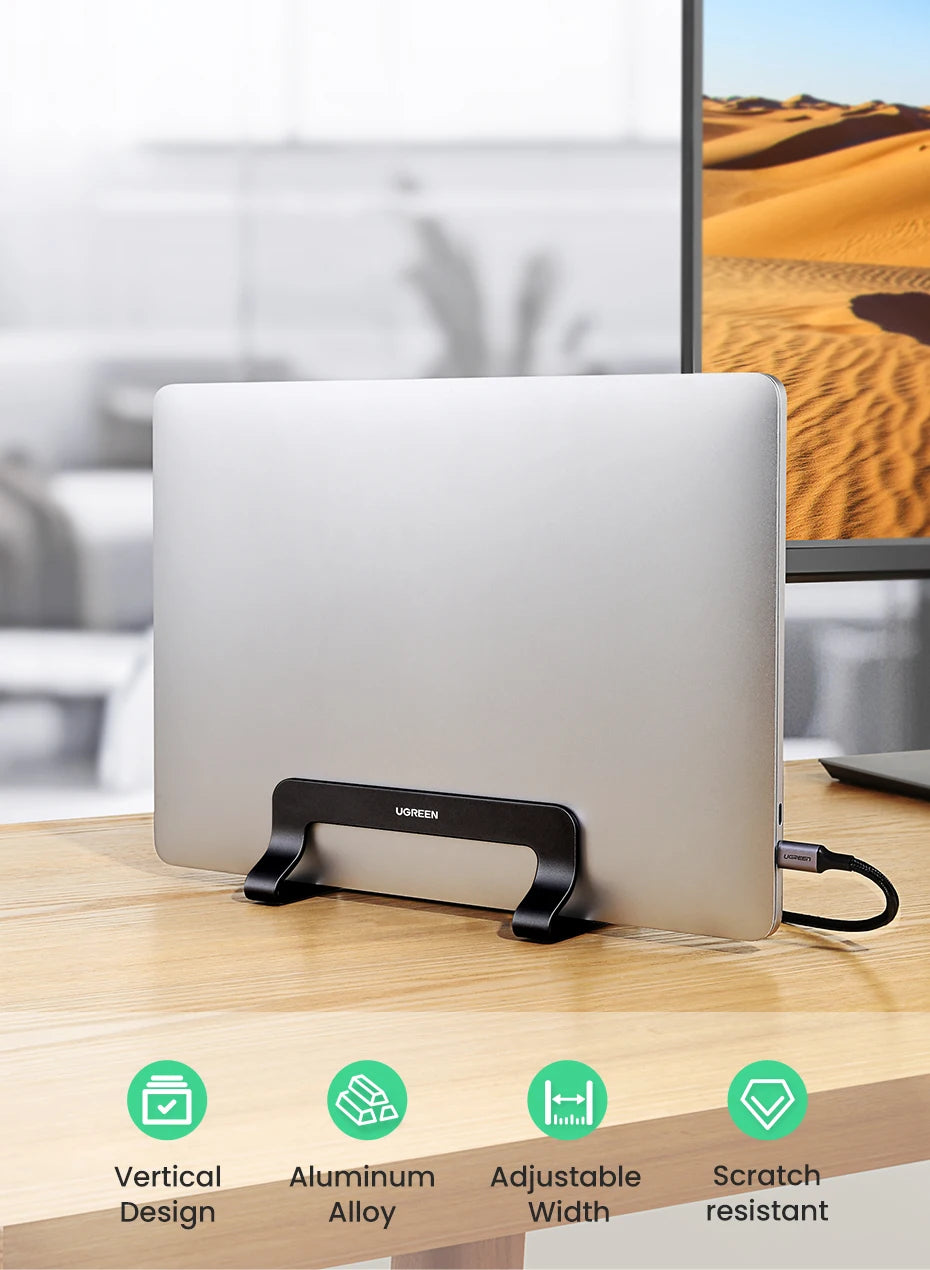 A silver vertical laptop stand is shown on a wooden desk with features like a vertical design, aluminum alloy, adjustable wid