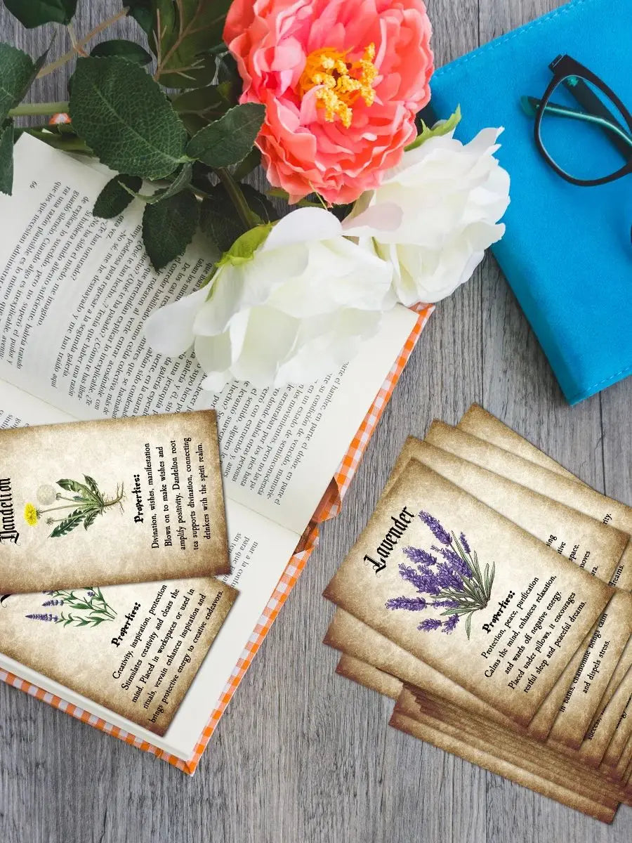 A collection of botanical herbal reference cards featuring pressed flowers and text, laid out on a wooden surface.