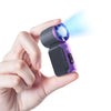 A hand holds a mini portable ice cooling fan, showing its purple and black design with blue light emanating from the front.