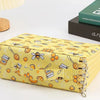 A yellow pencil case with bee and honeycomb patterns is shown on a white surface.