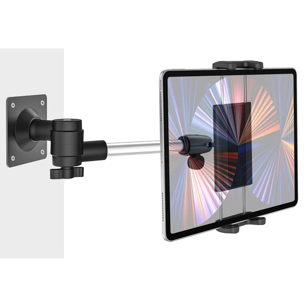 An aluminum wall mount tablet holder with a swivel arm positioned next to a tablet display.