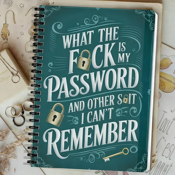 A teal spiral notebook titled What the fuck is my password and other shit I can't remember with a gold key design.