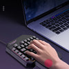 A hand is using a T-VOLF palm rest design on a laptop keyboard, demonstrating ergonomic support for wrist pressure.
