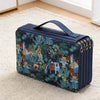 A dark blue pencil case with a tropical foliage pattern and multiple zippered compartments resting on a cream rug.