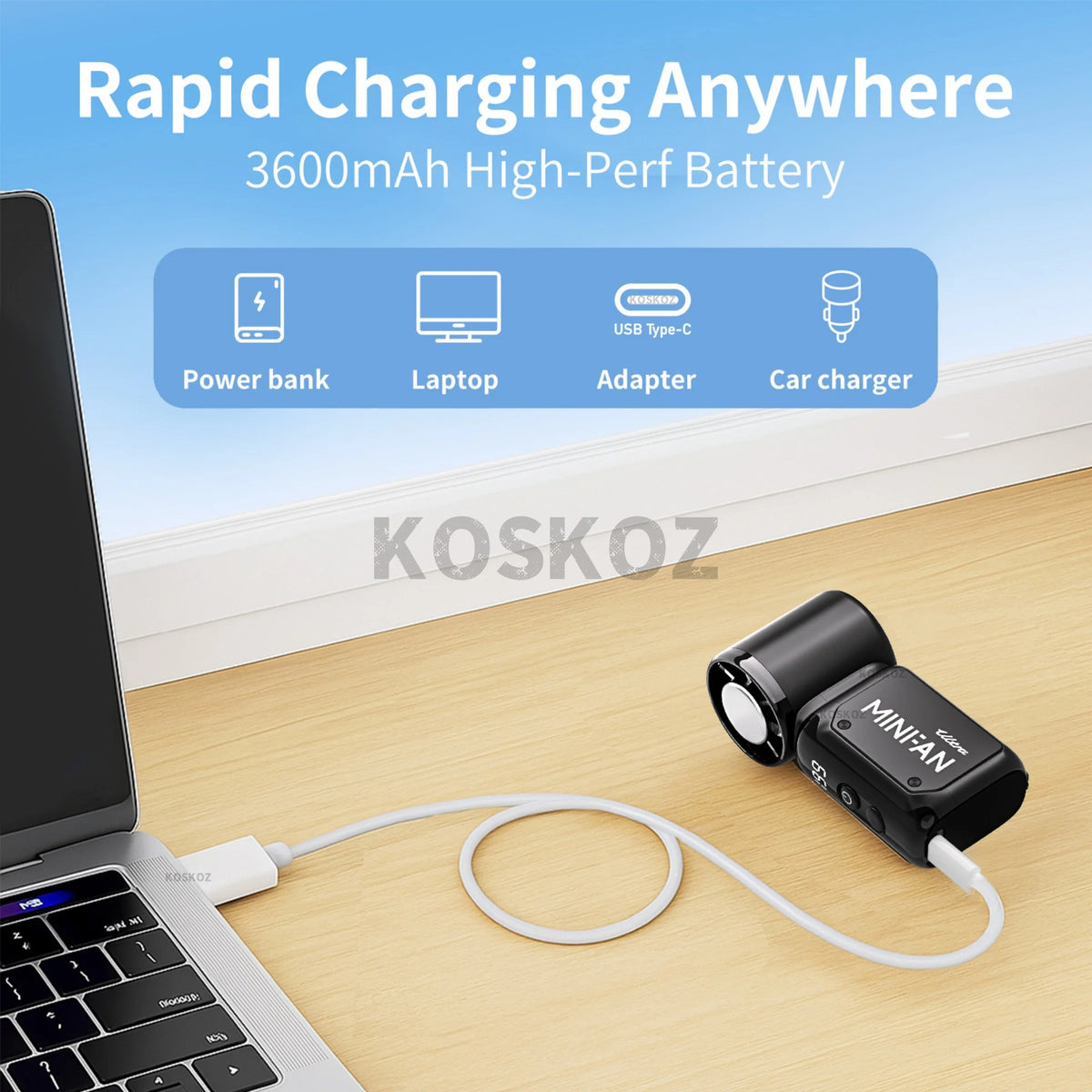 A black mini portable ice cooling fan is shown with a white cord on a wooden desk.