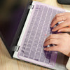 Eine Hand tippt auf einem Laptop mit einer installierten Silikon-Tastatur-Schutzfolie.