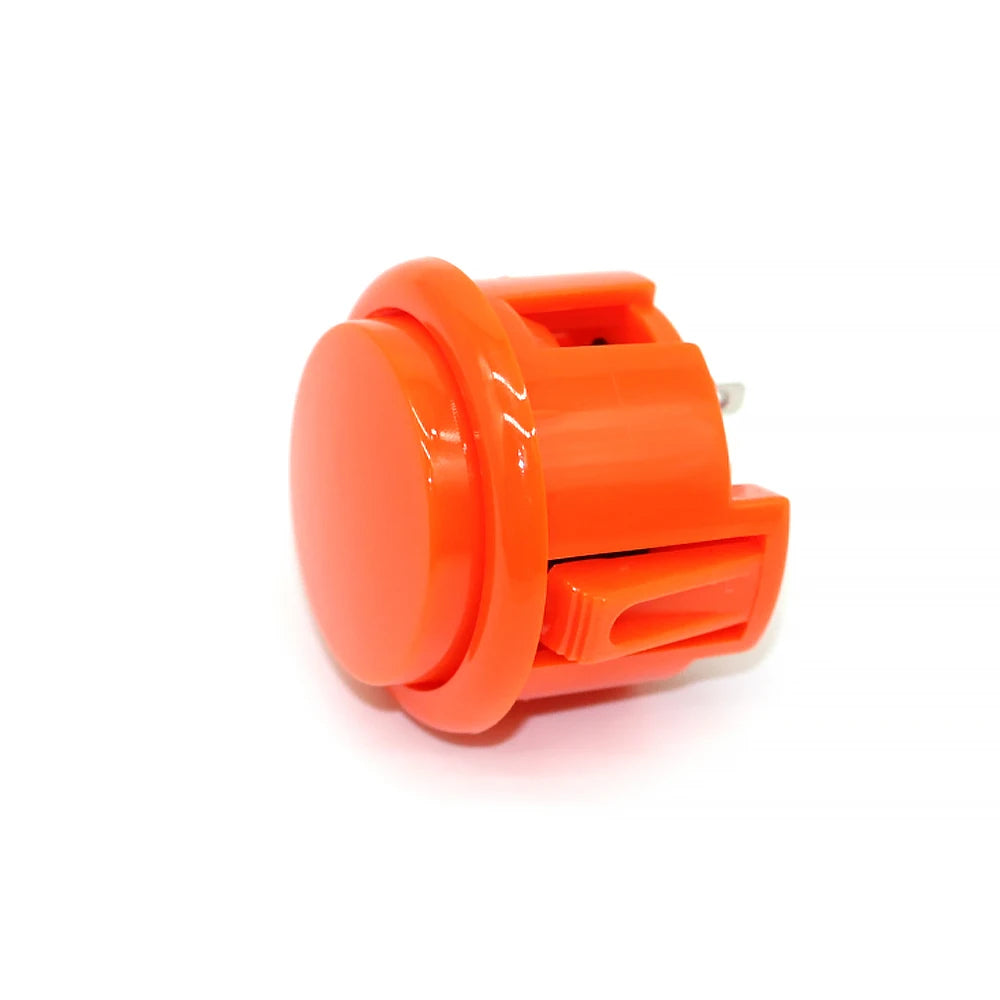 An orange arcade push button game switch with a plastic housing.