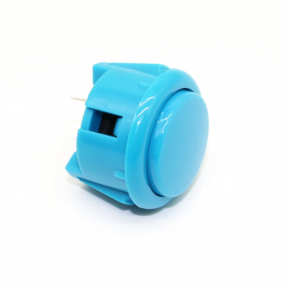 A light blue arcade push button game switch with a small metal pin visible.