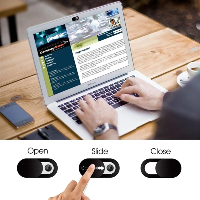 A hand is shown sliding a privacy camera cover onto a laptop to protect the device.