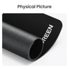 A black non-slip rubber mouse pad rolled up, showing the word GREEN on the side.