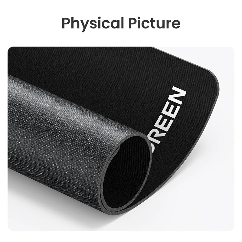 A black non-slip rubber mouse pad rolled up, showing the word GREEN on the side.