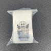 A clear plastic ziplock jewelry bag containing a small charm with the text Good Luck