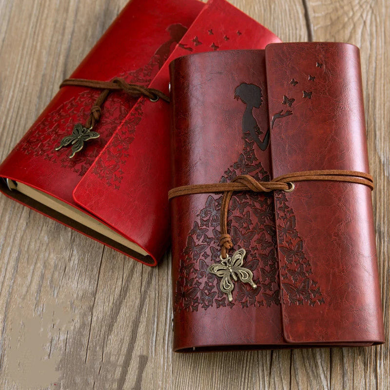 A set of two vintage red and brown PU leather A6 journal notebooks tied with leather cords