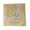 A square tan cotton scarf featuring an intricate white paisley print border.