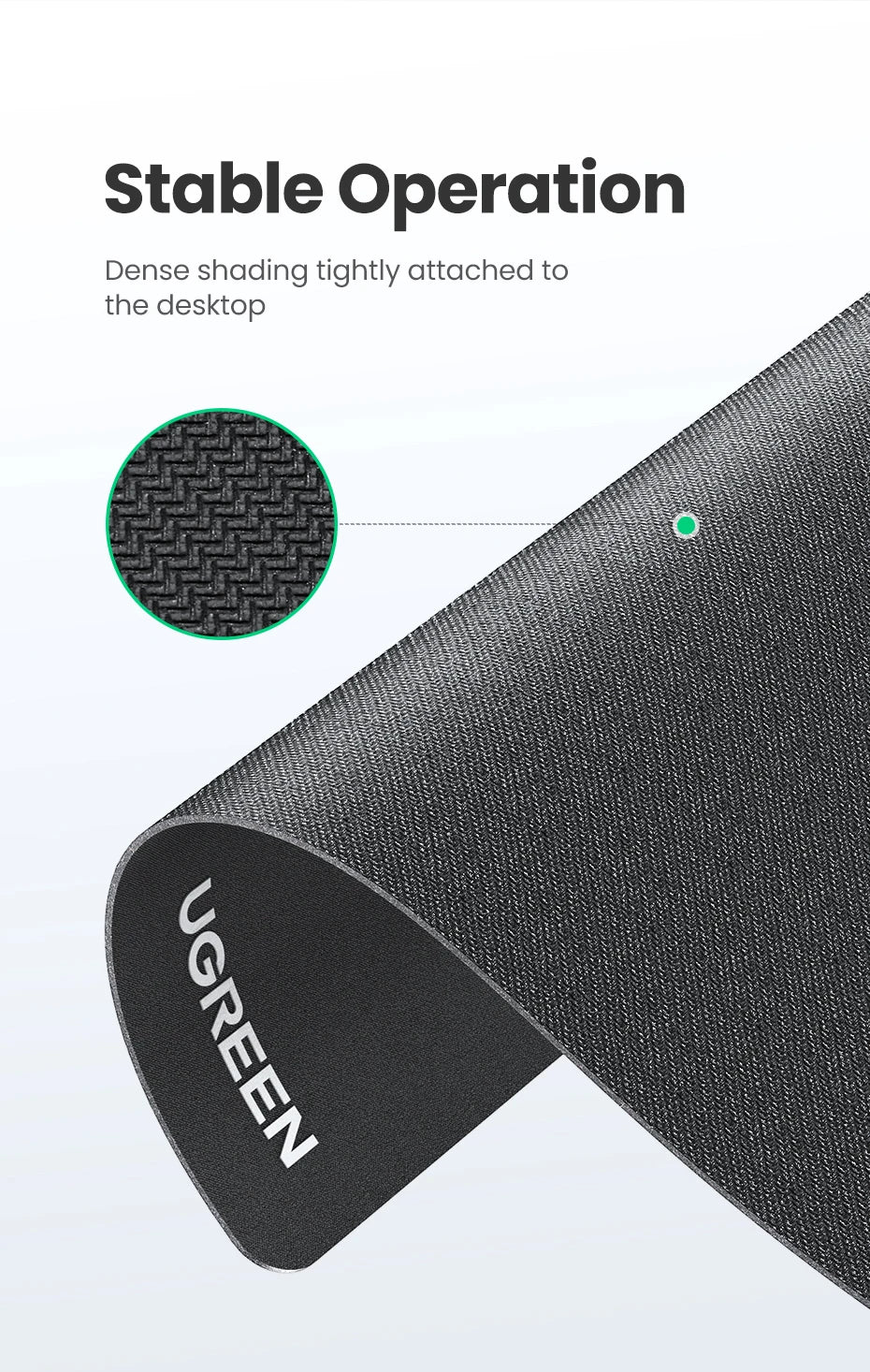 Close-up view of a black non-slip rubber mouse pad with a textured surface attached to the desktop.