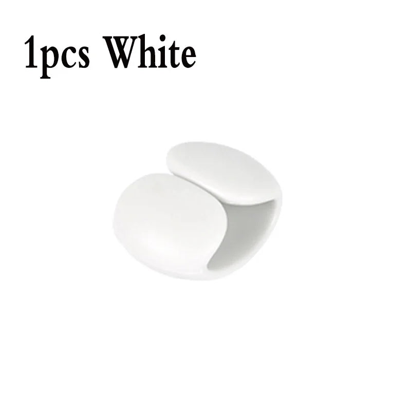 One white silicone cable organizer clip.