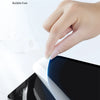 A hand is applying a clear matte screen protector to an iPad screen.