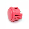 A pink arcade push button game switch with a plastic housing and metal pin.