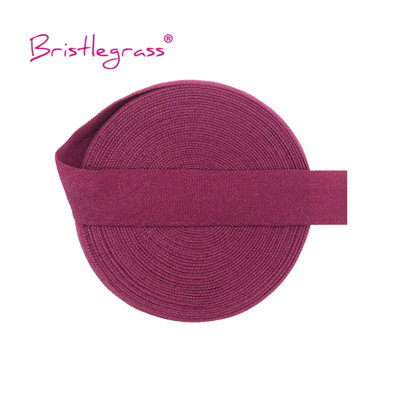 A maroon elastic hair tie with a ribbed texture and a flat band for adjustment.