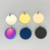 Five round stainless steel charm pendants in white, yellow, pale cream, purple, and black.