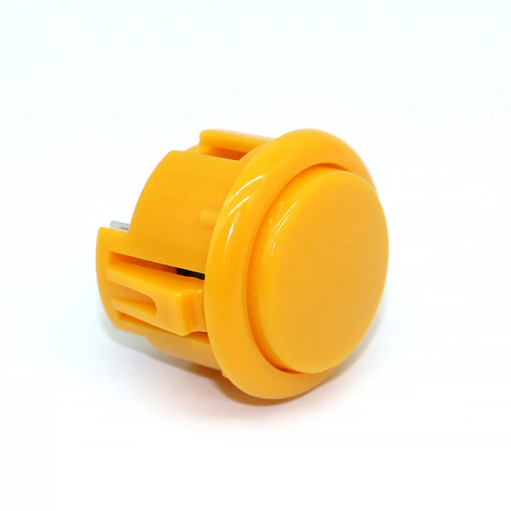 A bright yellow arcade push button game switch with a round, translucent top.