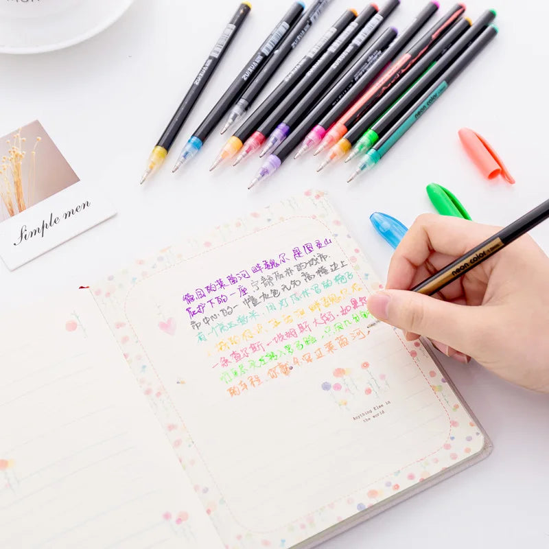 A hand holds a set of twelve colored glitter gel pens arranged diagonally on a white background.