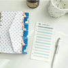 A set of six-color budget planner cards with various designs and a budget sheet are displayed on a white surface.