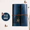 A dark blue leather journal notebook with black butterfly designs on the cover.