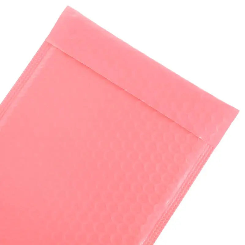 A close-up view of a pink bubble mailer, a self-sealing padded envelope.