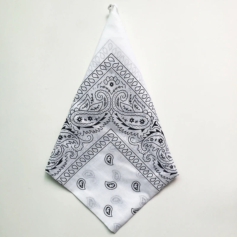 A white cotton bandana square scarf featuring an intricate black paisley print.