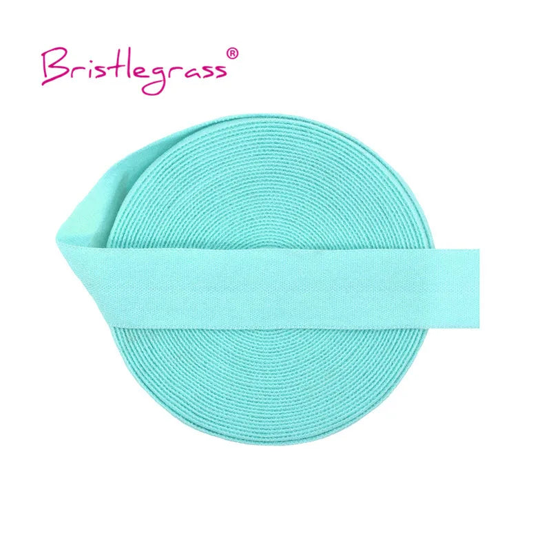 A light turquoise elastic hair tie or trim, wrapped around a circular band.