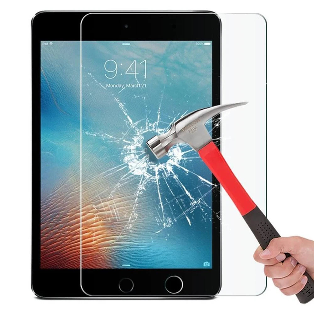 A hand holds a red and silver hammer next to an iPad screen protected by a clear tempered glass screen protector.