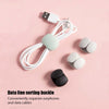 A white silicone cable organizer with multiple clips is shown on a pink background.