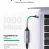 A silver USB to Ethernet adapter cable with a green connector is shown next to a computer port.