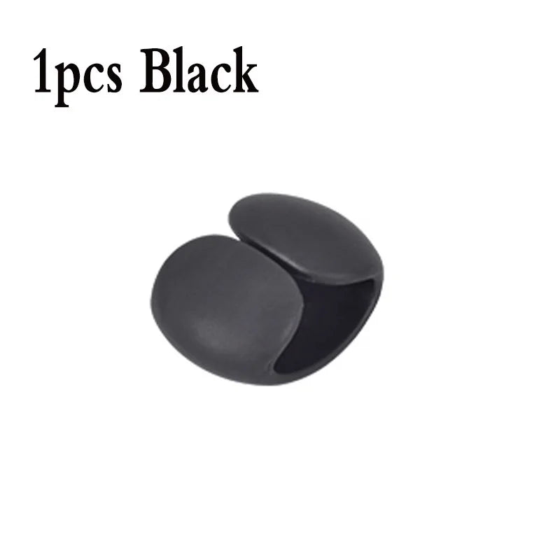 A single black silicone cable organizer clip.