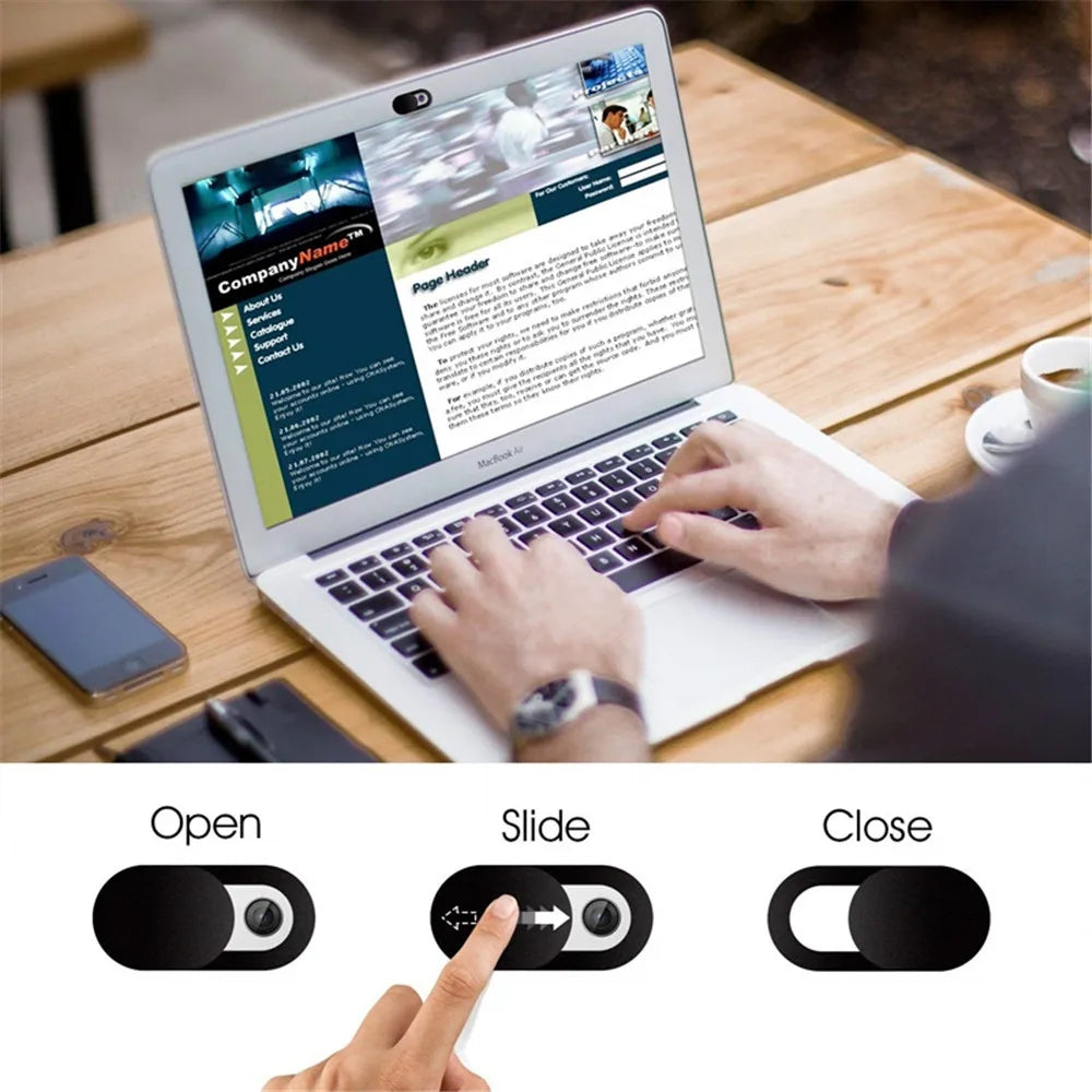 A hand is shown sliding a privacy camera cover onto a laptop screen to protect the camera.