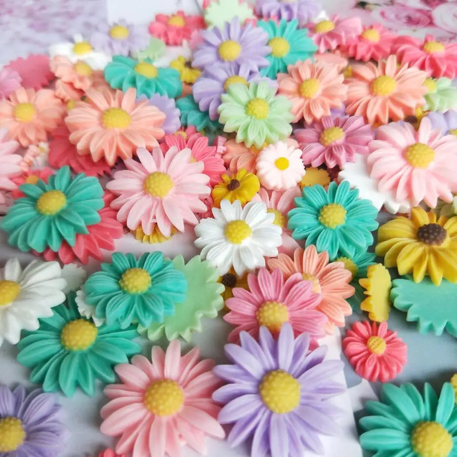 A colorful arrangement of multicolor sunflower flatback resin cabochons in various shades of pink, purple, yellow, and green.