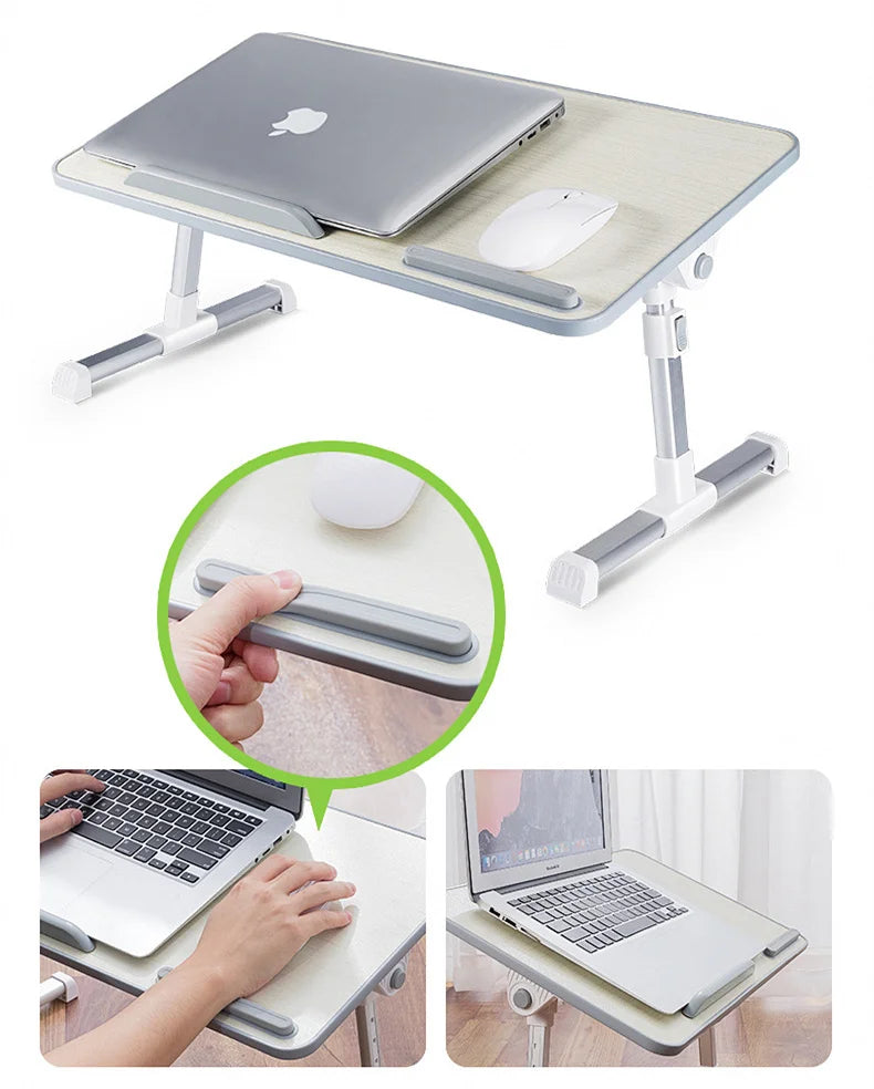 A portable adjustable laptop desk stand with a light gray finish, shown in use on a table.