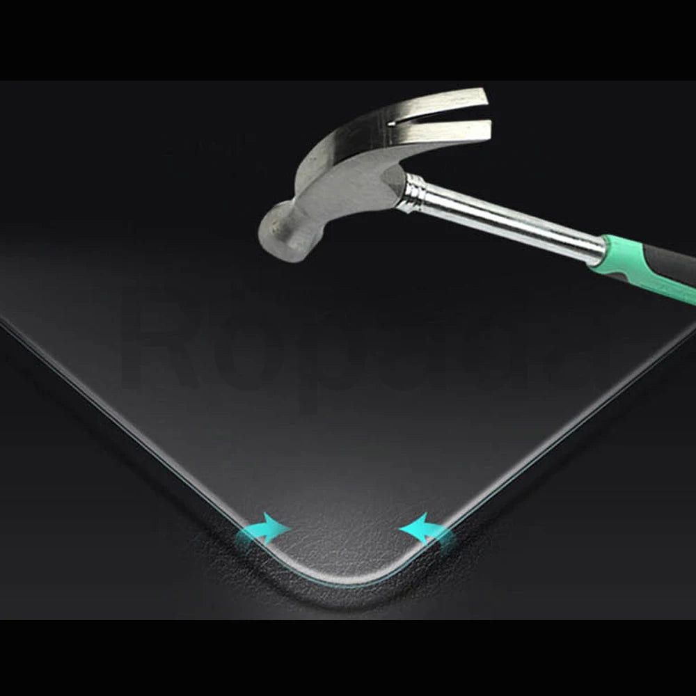 A silver and green tempered glass screen protector is shown resting on a dark surface.