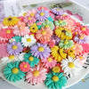 A colorful arrangement of multicolor sunflower flatback resin cabochons for crafts and DIY projects.