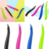 A collection of magnetic staple removers in various colors including pink, black, blue, and lime green.