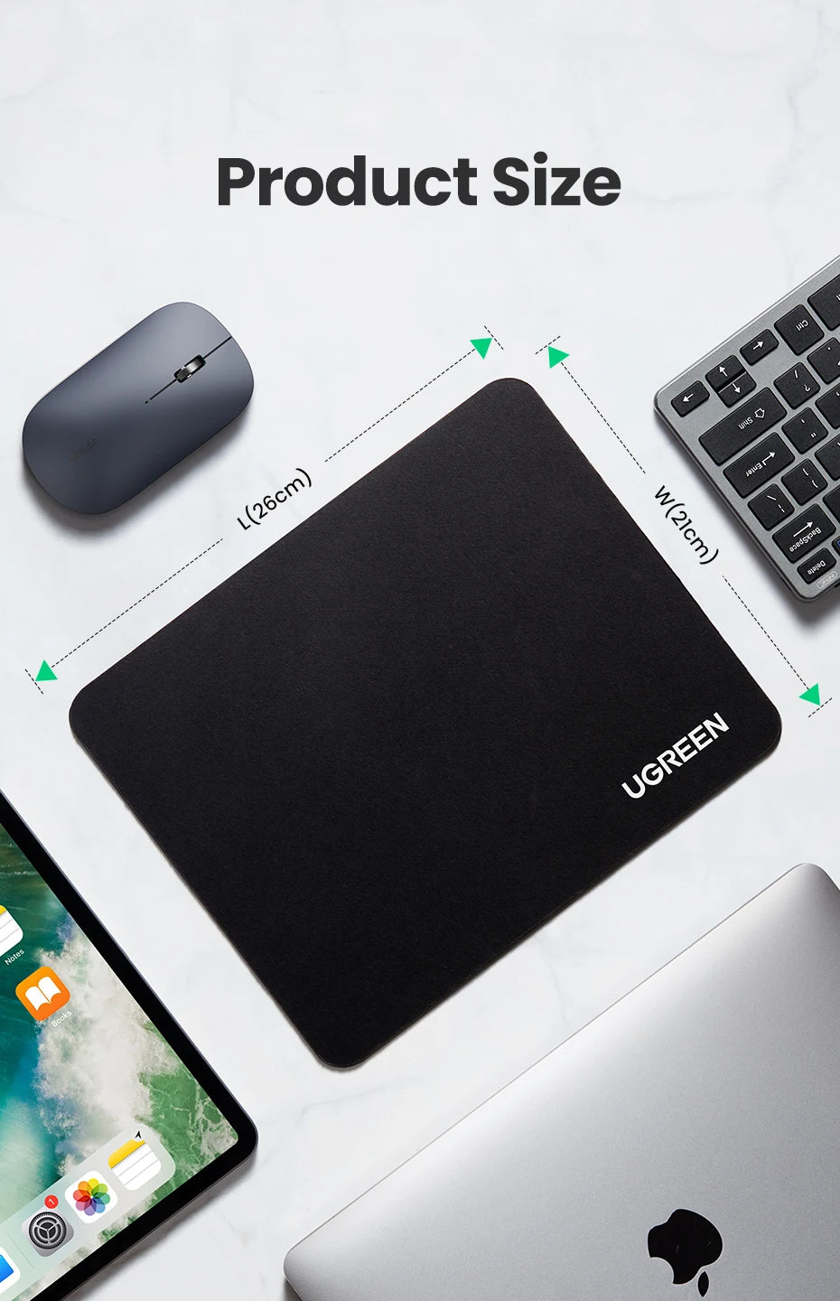 A black non-slip rubber mouse pad is shown next to a computer mouse and a laptop.